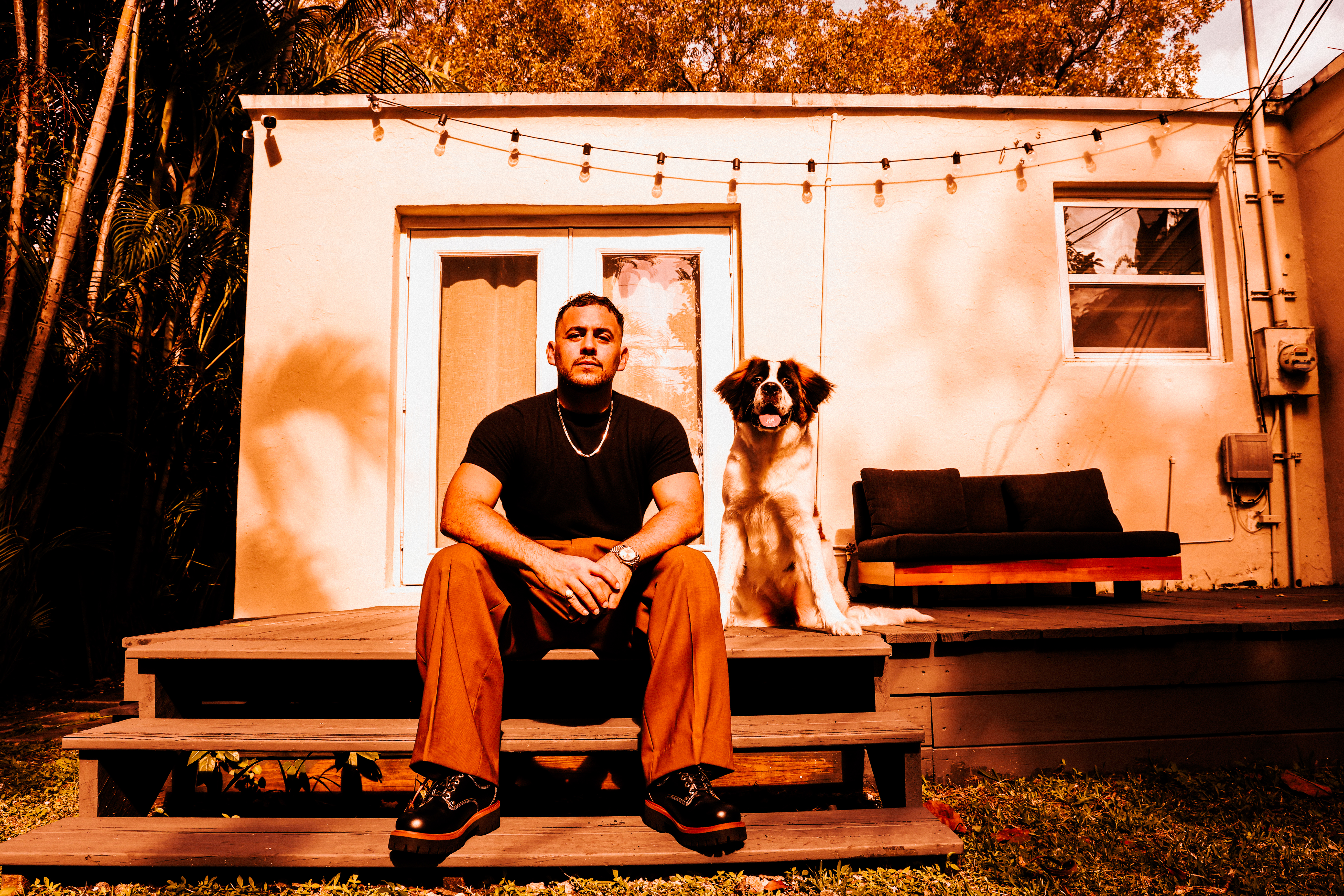 Gonzalo Rangel and Skai, the GMR Saint Bernard, on the porch steps